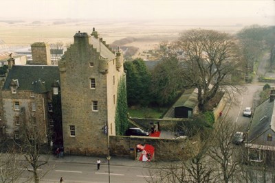 Bride at garden entrance of Dornoch Castle Hotel