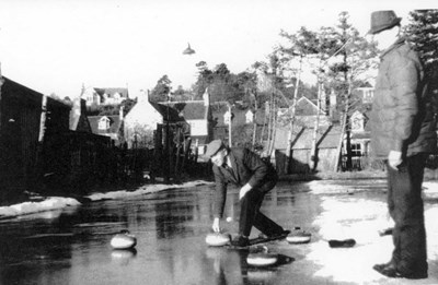 The Meadows curling pond with Dornoch houses in the background