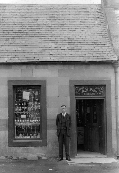 Photograph of Mr Paul outside his shop in Golspie.