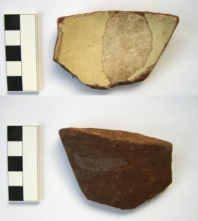 Edge piece of ceramic pottery, yellow-slipped glazed redware