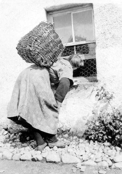 Fishwife at cottage window