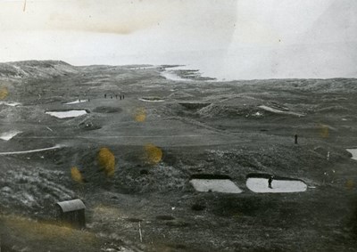 A golfer playing from one of the bunkers