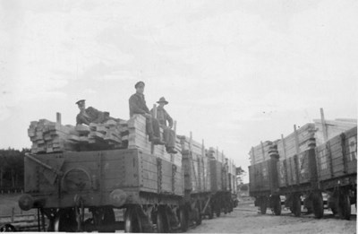 CFC troops with 7 waggons loaded wirh timber