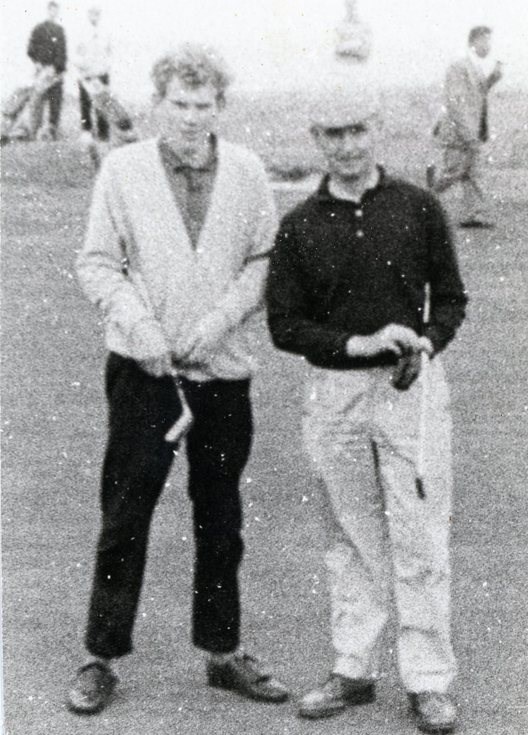 Two golfers posing for the camera