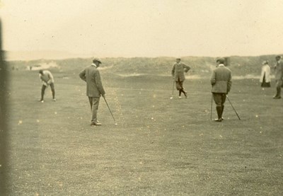Early photograph of golfers putting