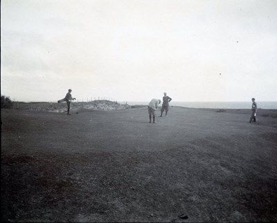 Golfers and caddies on the course