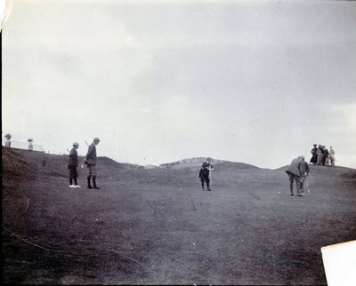 Golfers and spectators on the course