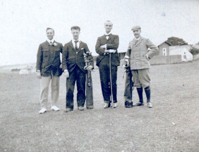 Four golfers pose for a photograph
