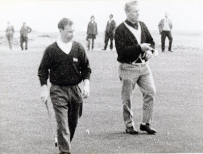 Two golfers with a small following