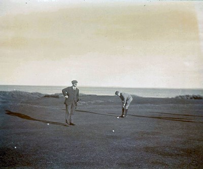 Putting with the sea in the background