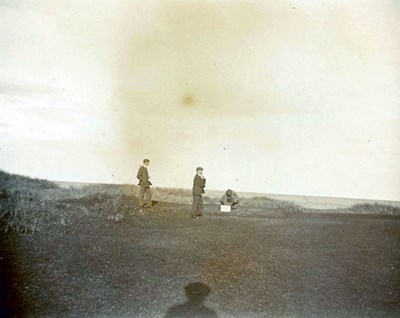 Two golfers with a view out to sea