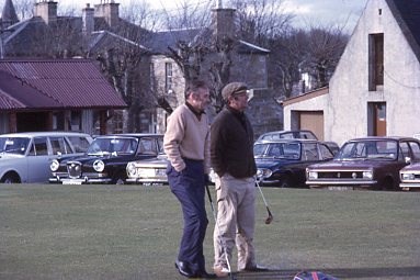 Two golfers at the Royal Dornoch clubhouse