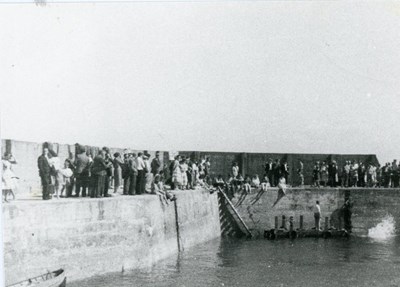 A crowd gathered at Embo Pier