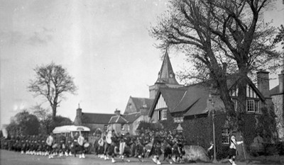 Pipe band with marching troops Dornoch Square