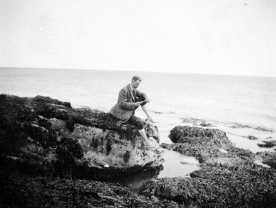 Gentleman sitting on the rocks at Dornoch beach