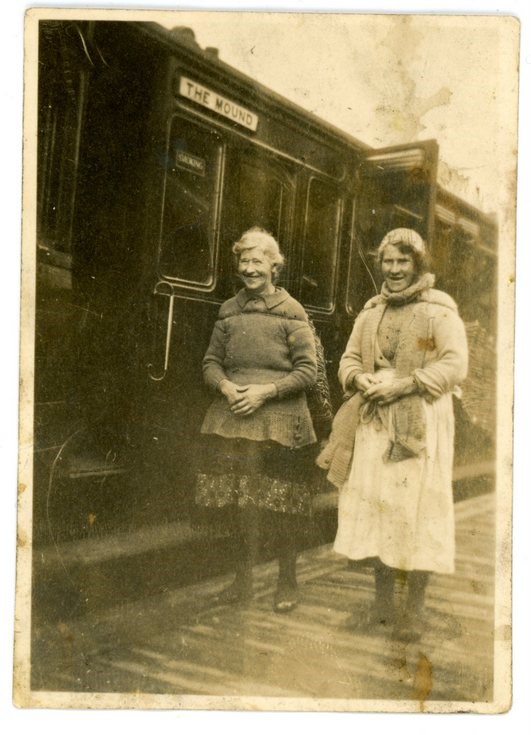 Barbara (Ross) Fraser carrying fish at the Mound