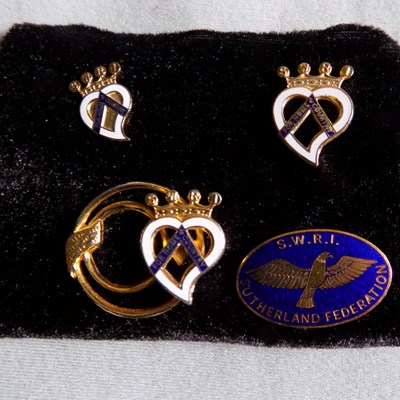 A collection of 4 lapel badges of the Sutherland Federation of the SWRI.