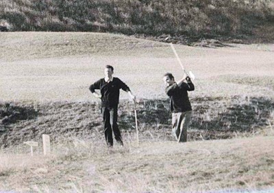 Two golfers teeing off