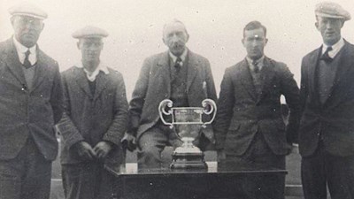 Five golfers with their trophy