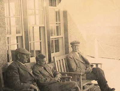 Group of three gentlemen on the Club veranda.