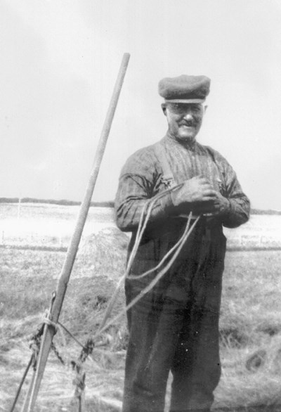 Photograph of Billy MacKenzie with hand operated hay rake.