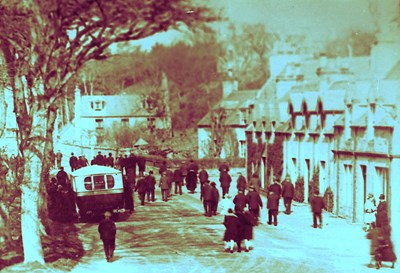 Bus parked at Bridge Street with people walking alongside