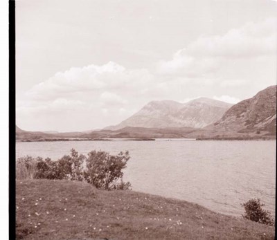 Photograph of a loch with mountains