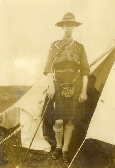 Scout leader standing in door of a bell tent