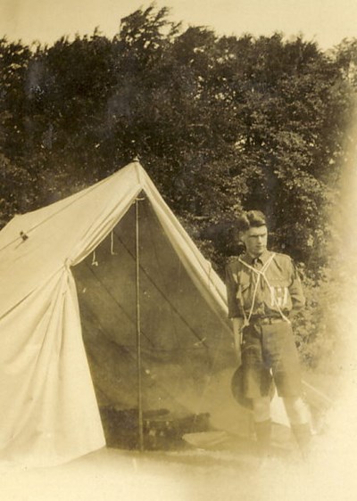 Scoout Troop Leader standing in front of ridge tent