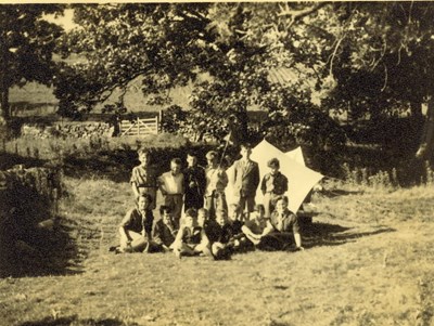 Group of scouts at a woodland camp site