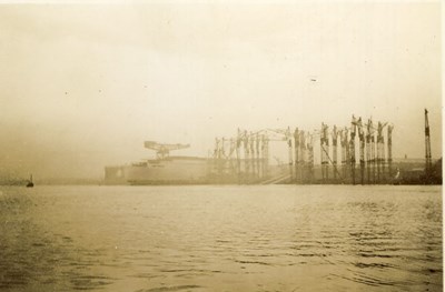 Ship under construction, surrounded by Cranes