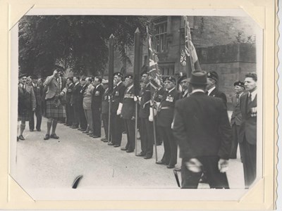 Inspecting officer salutes new King's Colours 1951