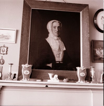 Portrait of a woman over mantlepiece