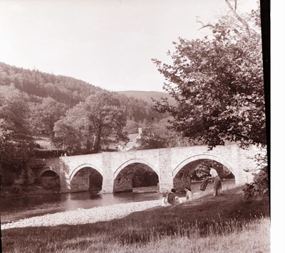 From a different viewpoint a family group by river  bridge