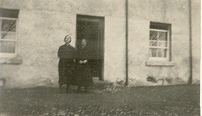 Two ladies in front of Three Trees