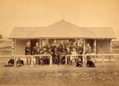Photograph of a group of golfers in front of the original clubhouse in the late 1880s