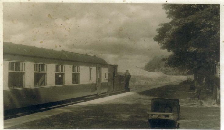 Train standing at Dornoch Station with Tom Fraser driving