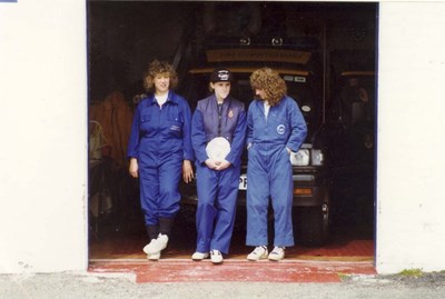 HM Coastguard Station members at garage door